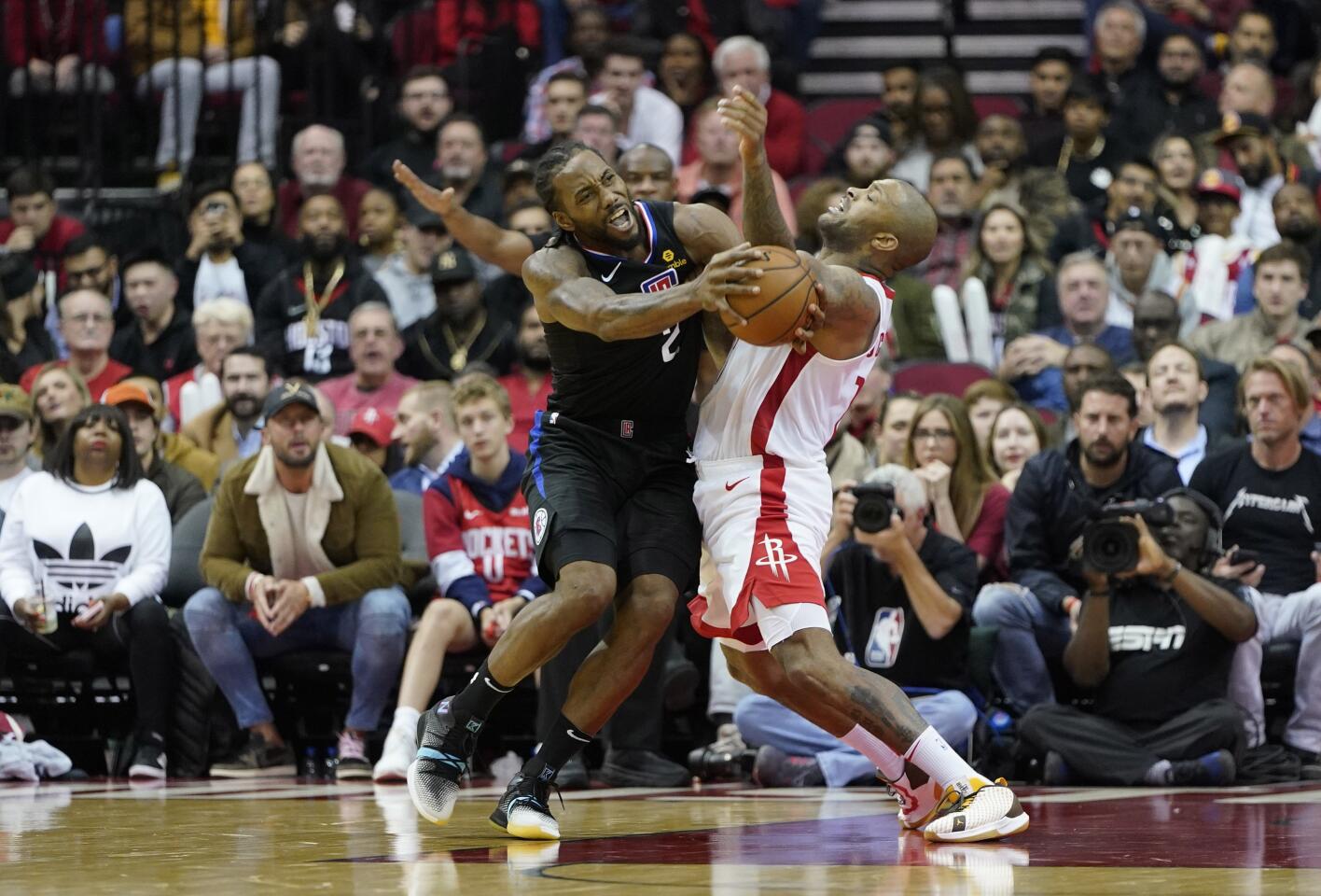 Clippers forward Kawhi Leonard (2) is fouled by Rockets forward PJ Tucker during the second half of a game Nov. 13.