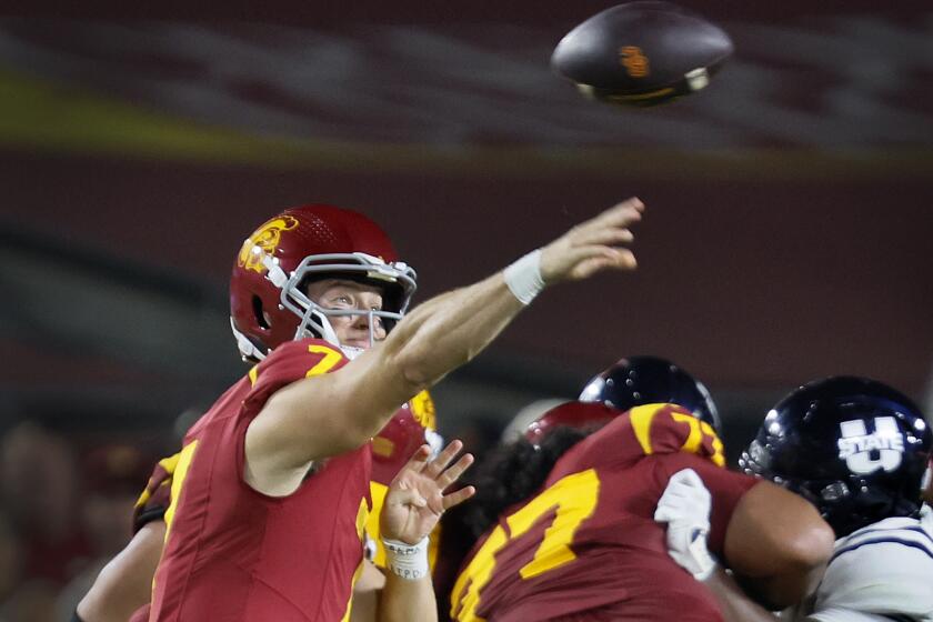 Los Angeles, CA - September 07: USC starting quarterback Miller Moss, #7, left, passes the ball during the second half against Utah State in the USC home opener at LA Memorial Coliseum in Los Angeles Saturday, Sept. 7, 2024. (Allen J. Schaben / Los Angeles Times)