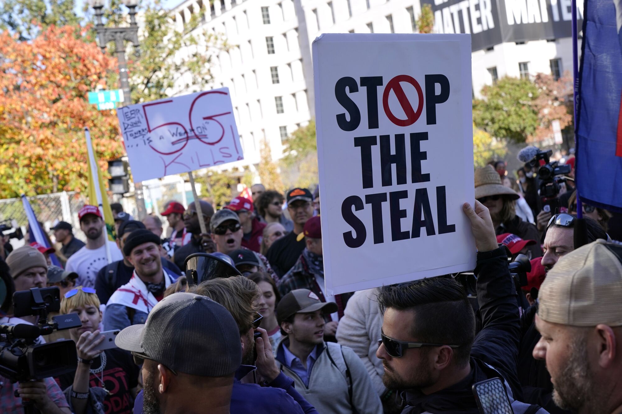 People carry signs including one reading, "Stop the Steal"