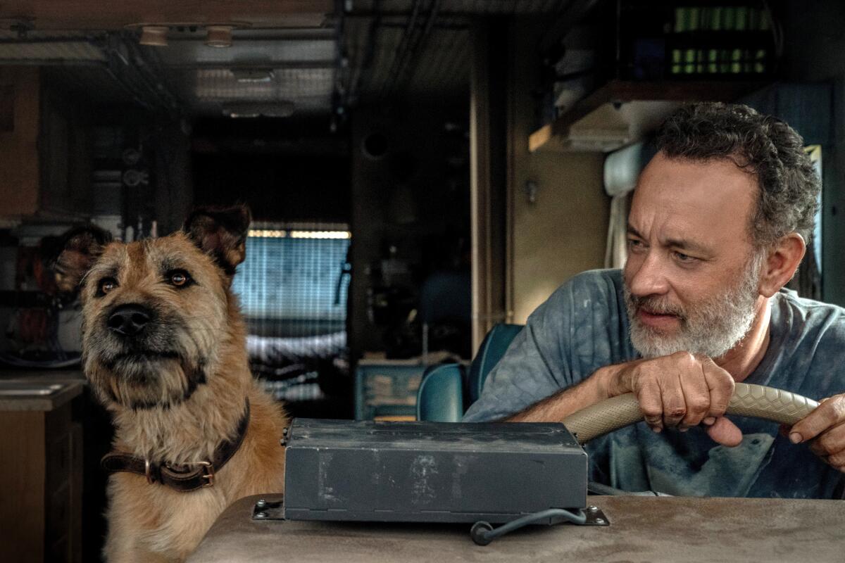 A dog and a man in an RV in the movie “Finch.”