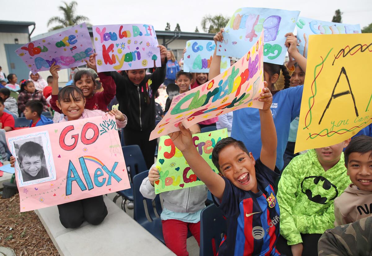 Kids at Oak View Elementary School show their support during the Special Olympics event on Friday.