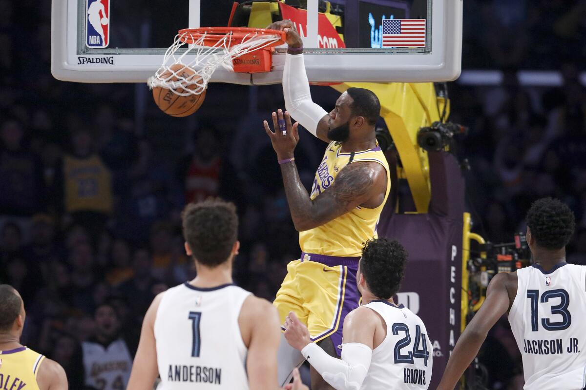 Lakers forward LeBron James throws down a dunk against the Grizzlies during a game Feb. 21, 2020, at Staples Center.