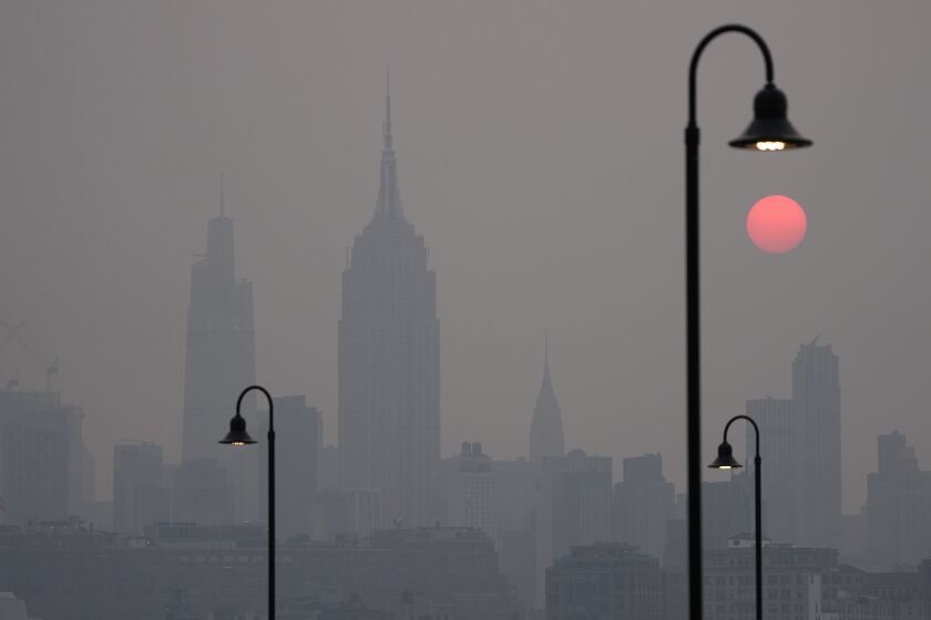 The sun rises over a hazy New York City skyline as seen from Jersey City, N.J., Wednesday, June 7, 2023. Canadian wildfires are blanketing the northeastern U.S. in a haze, turning the air acrid, the sky yellowish gray and prompting warnings for vulnerable populations to stay inside. (AP Photo/Seth Wenig)