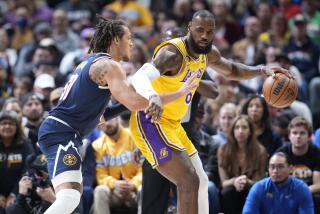 Los Angeles Lakers forward LeBron James, right, looks to pass the ball as Denver Nuggets forward Aaron Gordon.