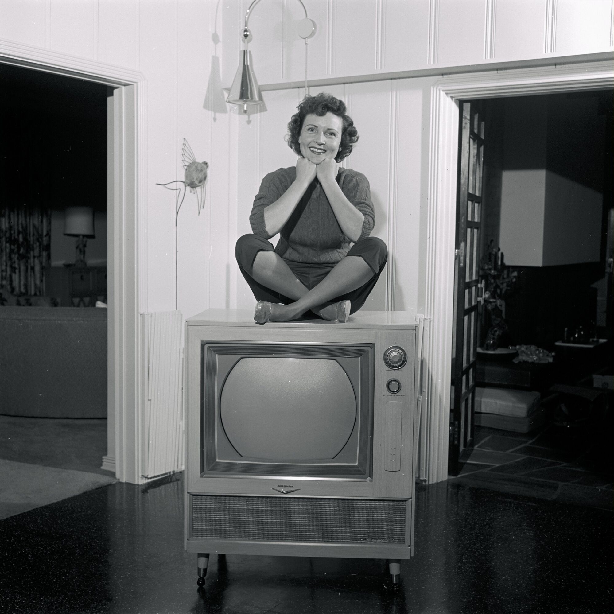 Betty White sits on a television for her special "Betty White at Home."