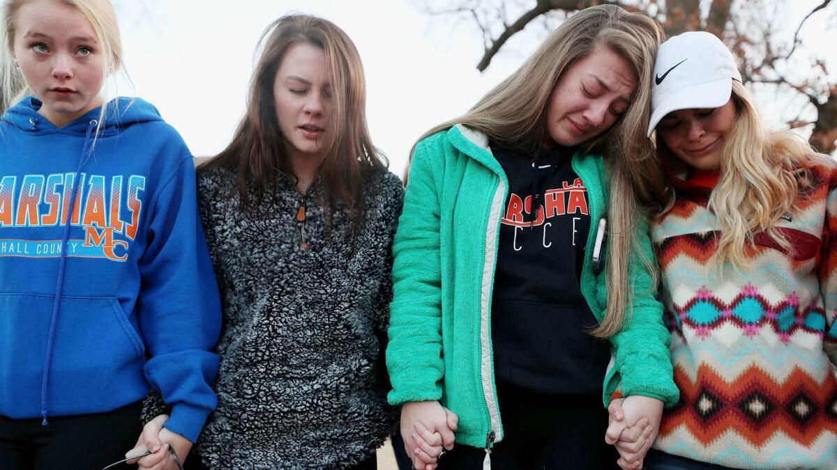 Students participate in a prayer vigil for the two people killed and 17 wounded in a mass shooting in Benton, Ky., on Jan. 23.
