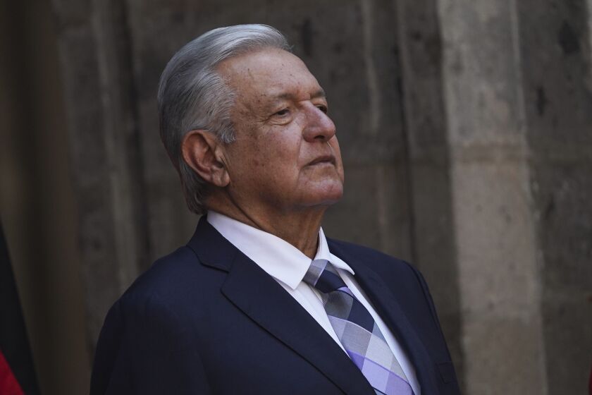 FILE - Mexican President Andres Lopez Obrador stands at the National Palace during a ceremony in Mexico City, Sept. 20, 2022. Lopez Obrador suspended a tour of the Yucatan peninsula Sunday, April 23, 2023, after acknowledging he tested positive for the cornavirus, having previously suffered two bouts of COVID-19. (AP Photo/Marco Ugarte, File)