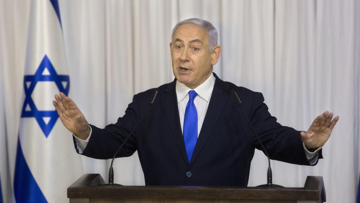 Israel's attorney general announced he plans to indict Prime Minister Benjamin Netanyahu, shown delivering a speech Feb. 21, on charges of fraud, bribery and breach of public trust.