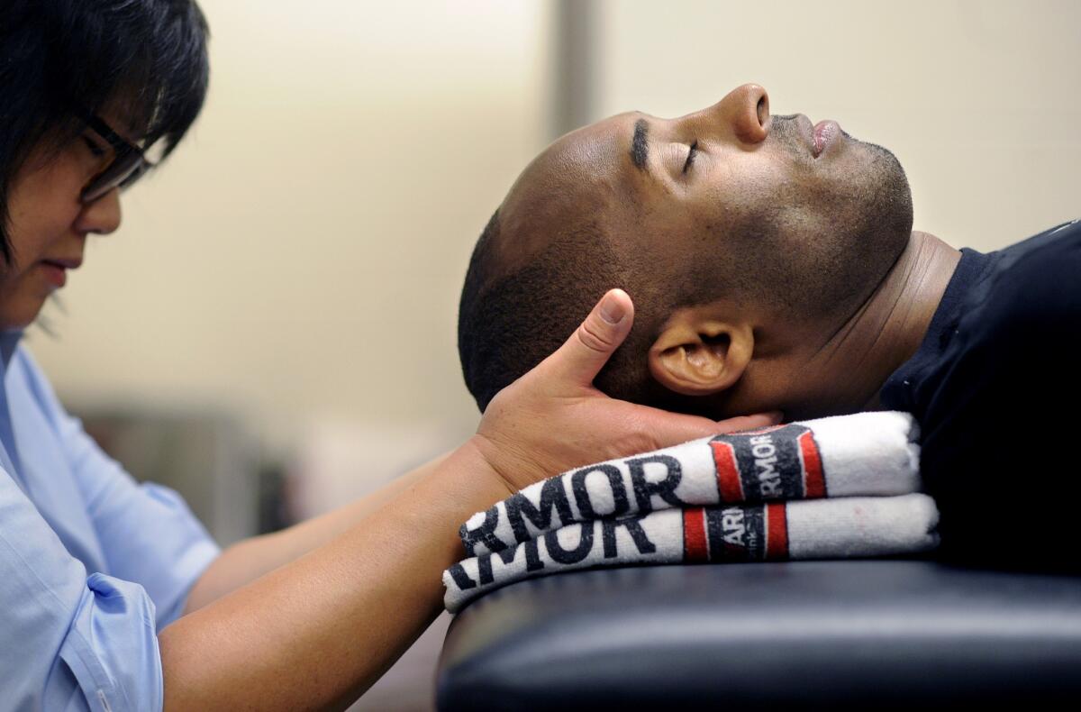 Kobe Bryant gets a massage from physical therapist Judy Seto before a game in 2016.