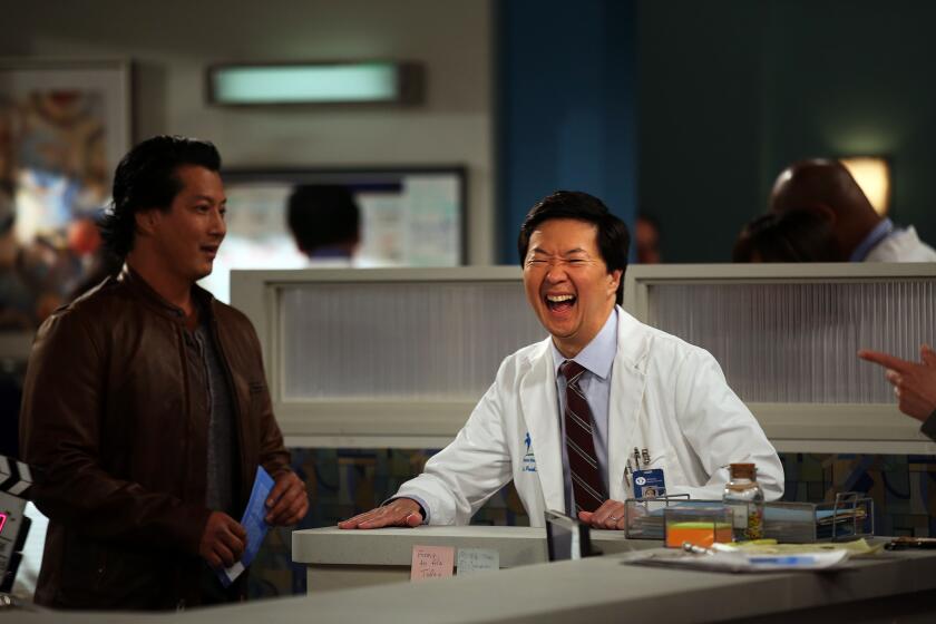 Actor Ken Jeong, center, laughs with actor Will Yun Lee in between takes on "Dr. Ken."