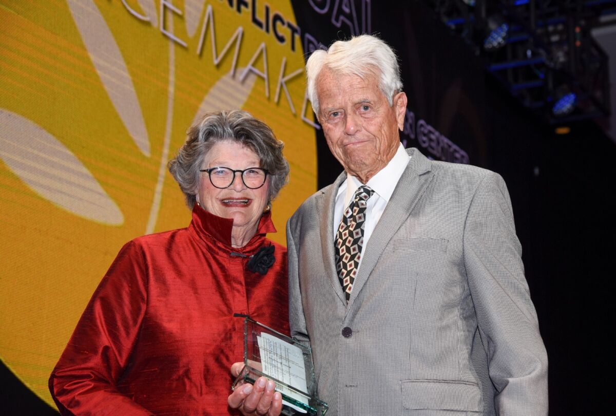 Mary Walshok presents longtime civic leader Malin Burnham with the Philanthropy in Peacemaking award in 2019.
