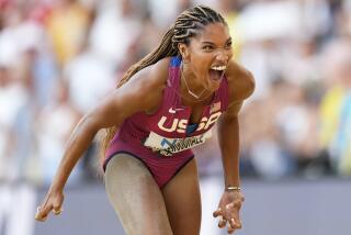 Tara Davis-Woodhall, of the United States, reacts after winning the silver medal in the women's long jump final during the World Athletics Championships in Budapest, Hungary, Sunday, Aug. 20, 2023. (AP Photo/Bernat Armangue)