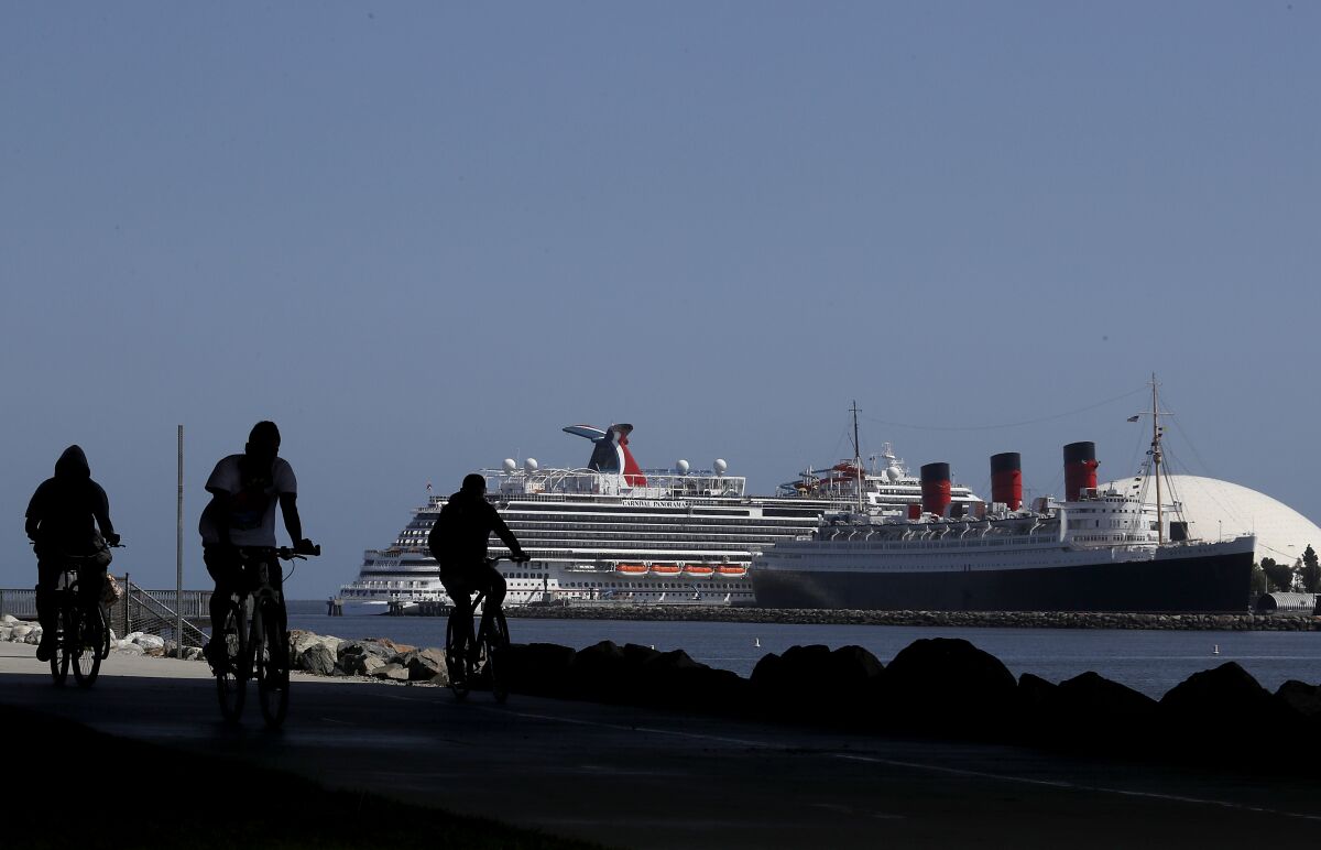 Cyclists have the bike path to themselves Friday along the shoreline in Long Beach.