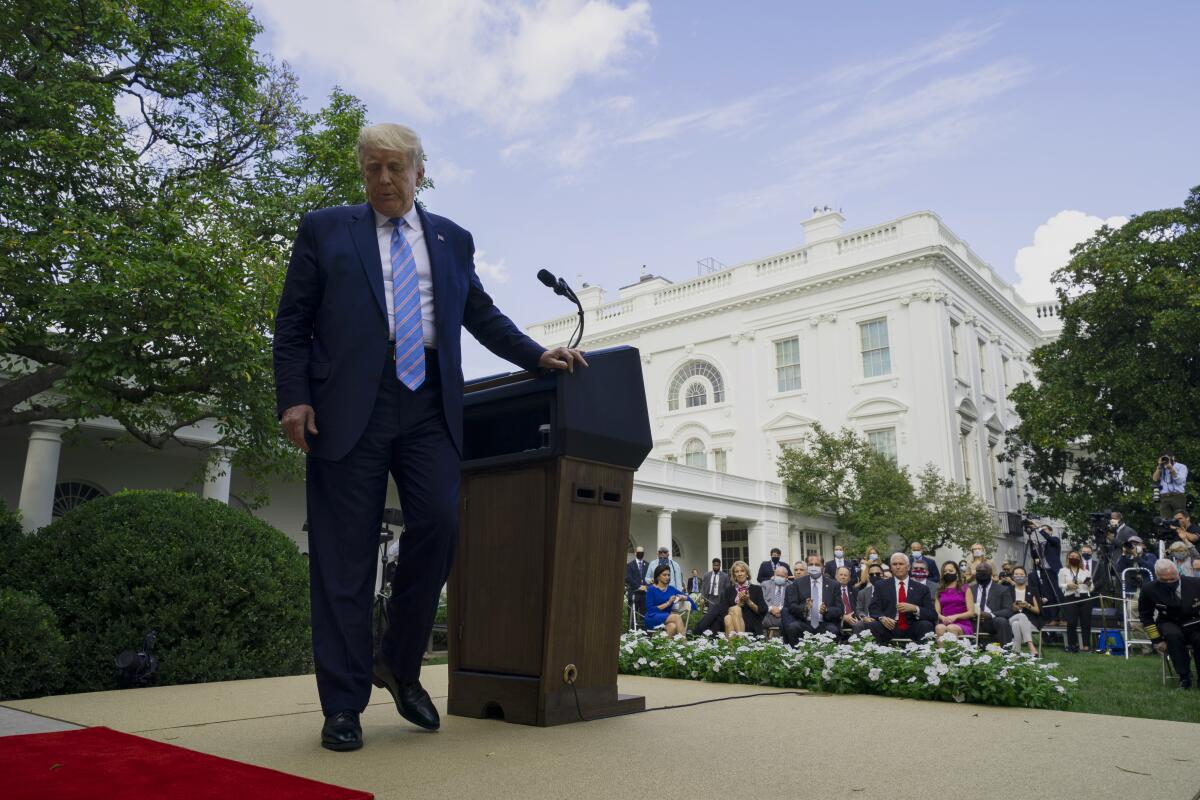 President Trump walks from lectern after speaking in the White House Rose Garden