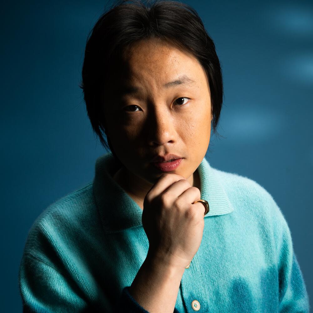 Jimmy O. Yang holding his hand to his chin.