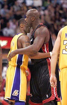 THE BIG GREET: Kobe Bryant and Shaquille O'Neal hug and pat each other on the back before the game between the Lakers and the Heat at Staples Center on Monday night.