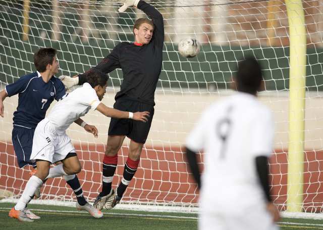 Paramount's Antonio Salgado heads a ball past Corona del Mar's keeper Connor Gaal during a CIF Southern Section Division III semifinal game at Paramount High.