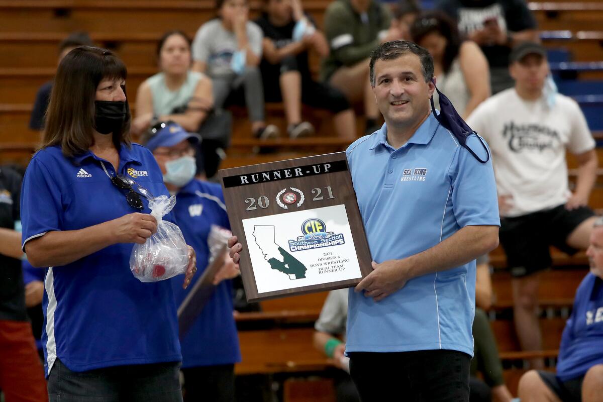 Corona del Mar High head coach Mark Alex accepts the runner-up plaque for his team.