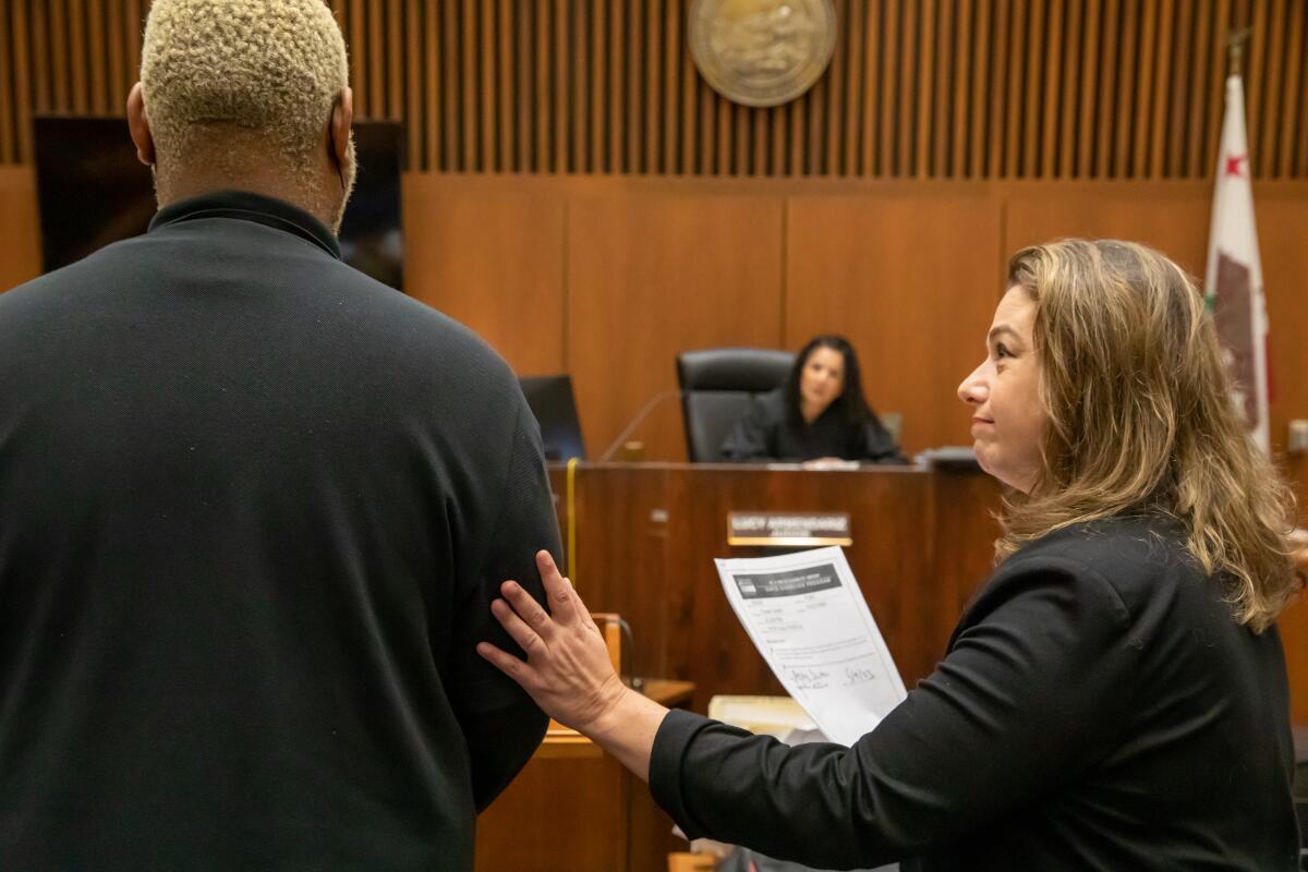 The defendant appears before Judge Maria Lucy Armendariz with his public defender, Caroline Goodson