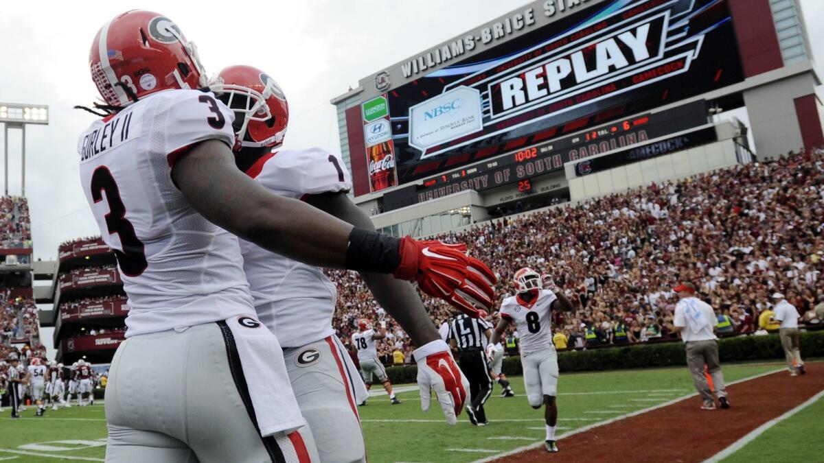 Georgia running back Sony Michel, right, celebrates with teammate Todd Gurley after scoring a touchdown against South Carolina in 2014.
