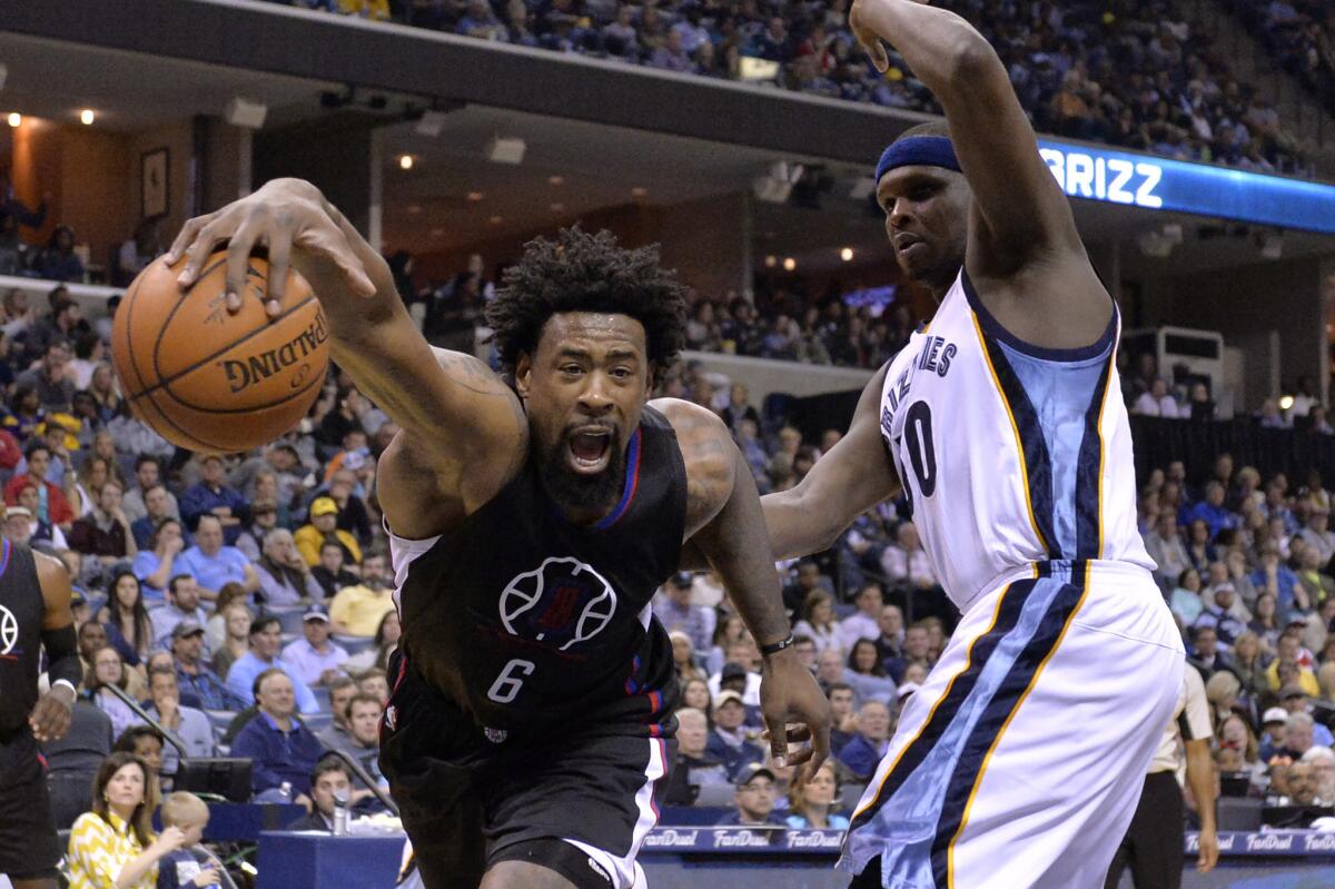 Clippers center DeAndre Jordan (6) struggles to stay inbounds against Grizzlies forward Zach Randolph (50) during the first half of a game on March 19.