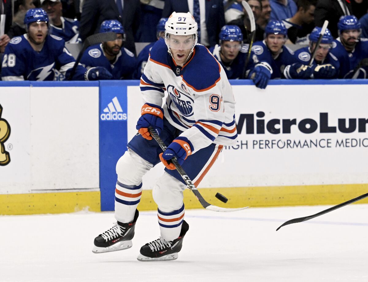 Edmonton Oilers center Connor McDavid (97) handles the puck during the first period of an NHL hockey game against the Tampa Bay Lightning Tuesday, Nov. 8, 2022, in Tampa, Fla. (AP Photo/Jason Behnken)