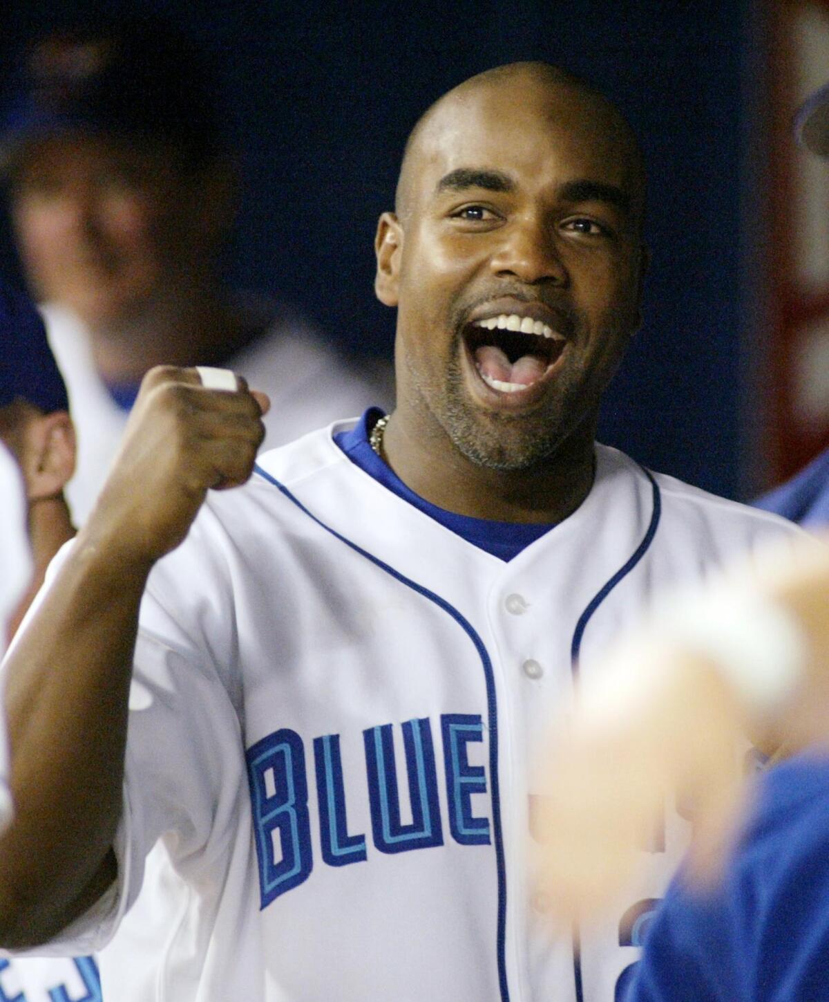 Carlos Delgado cheers during a game in which he hit four home runs for the Toronto Blue Jays against the Tampa Bay Devil Rays in September 2003.