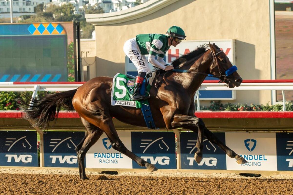 Flightline, ridden by Flavien Prat, is eased up at the wire as he wins the $1-million Pacific Classic.