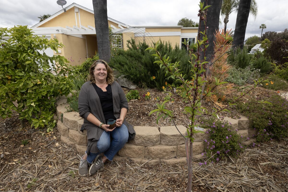 Jennifer Dell, winner of the Vista Irrigation District's WaterSmart Landscape Contest, sits in her front yard.