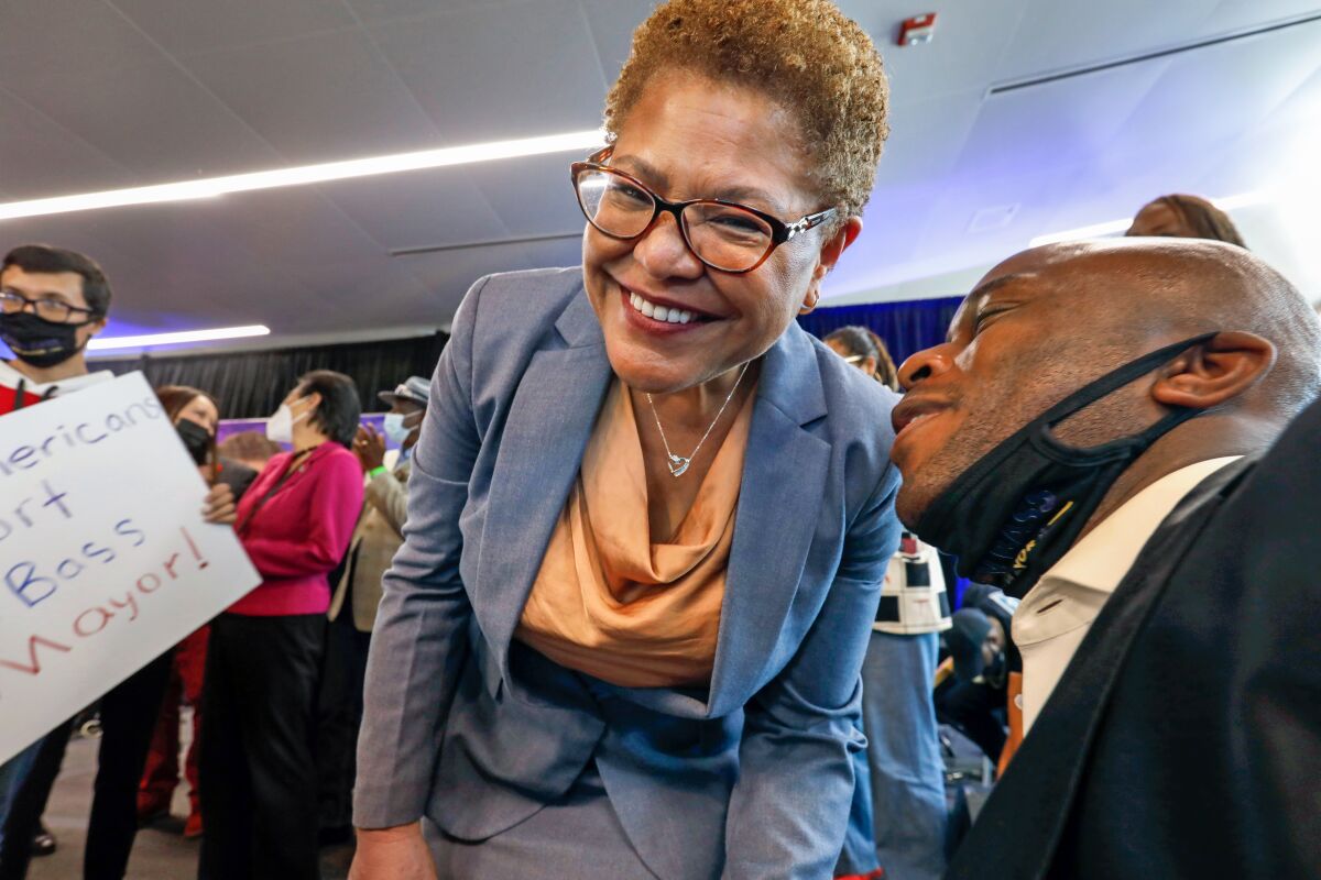 Mayoral candidate Karen Bass talks to a supporter