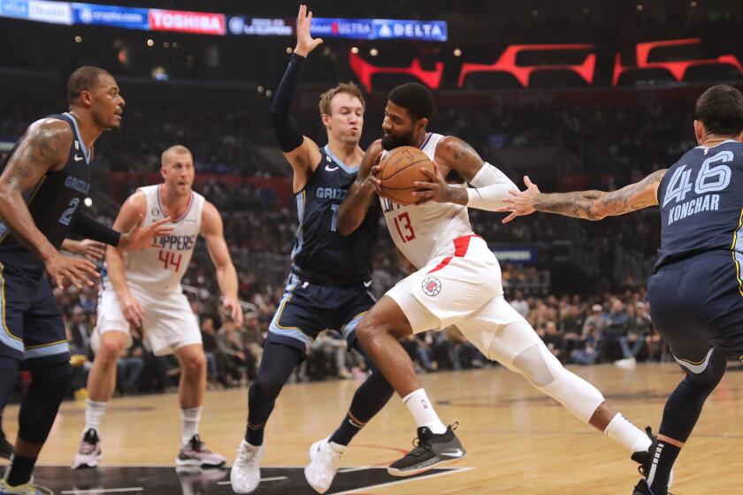 LOS ANGELES, CA - MARCH 05: The Clippers Paul George drives past Memphis Grizzlies' Luke Kennard.