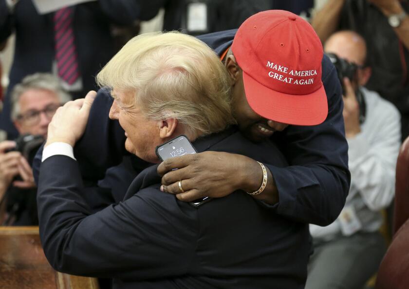 Kanye West and President Trump embrace at the White House. 