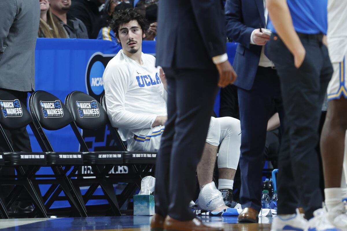 Jaime Jaquez Jr. sits on the bench with ice on his ankle during the Saint Mary's game.