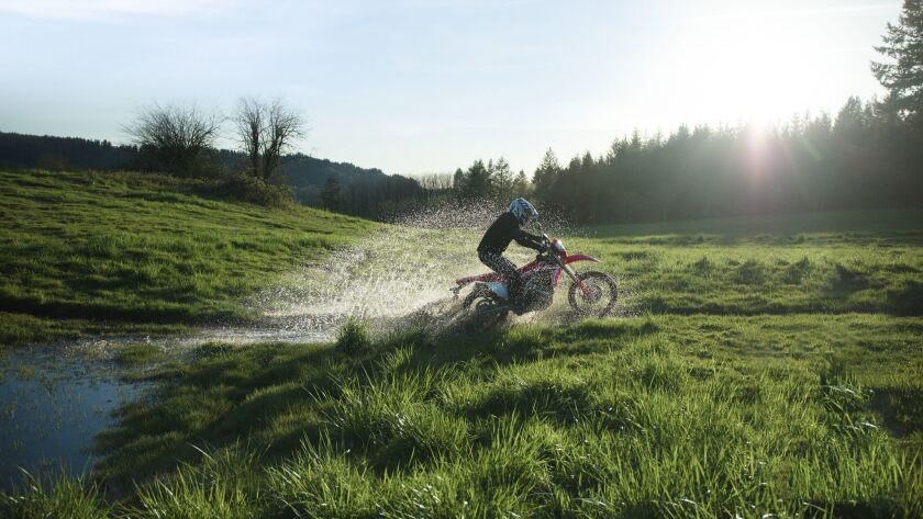 Hondas New Crf450l Motorcycle Straddles The Road And Dirt
