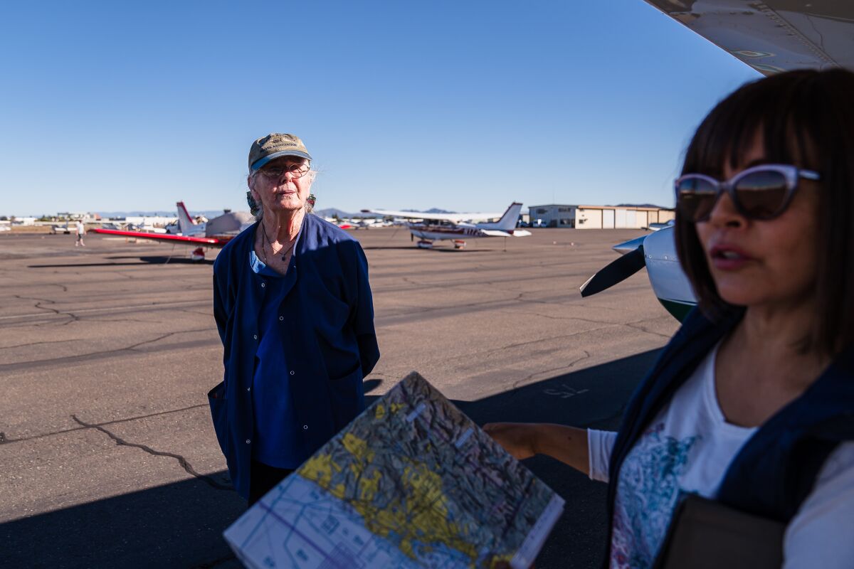 Ann Rothwell and flight instructor Tania Rose do a a preflight check at Montgomery-Gibbs Executive Airport.