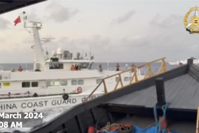 In this screen grab from video provided by the Armed Forces of the Philippines, a Chinese coast guard ship tries to block a Philippine resupply vessel Unaizah May 4 as it approaches Second Thomas Shoal, locally called Ayungin shoal, at the disputed South China Sea on Saturday, March 23, 2024. (Armed Forces of the Philippines via AP)