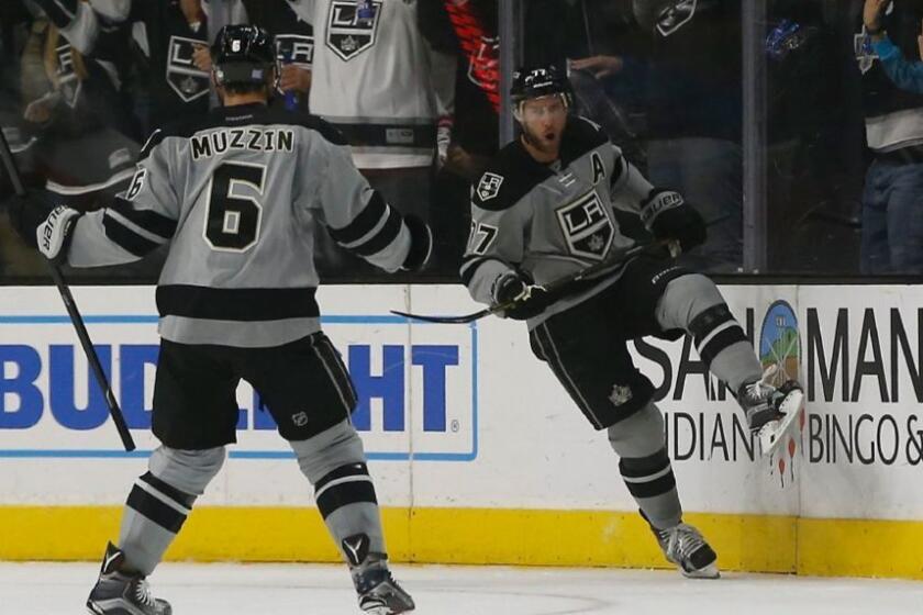 Kings forward Jeff Cater celebrates with defenseman Jake Muzzin after scoring a goal on the Flames during the first period of a game at Staples Center on Nov. 5.