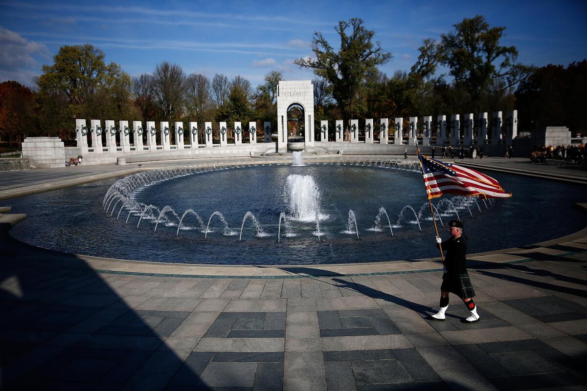 An honor guard participates in a Veterans Day ceremony at the World War II Memorial on Friday in Washington, D.C.