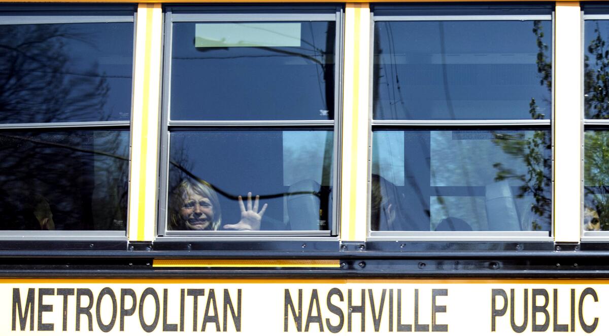 A child weeps on a bus leaving the Covenant School following a mass shooting