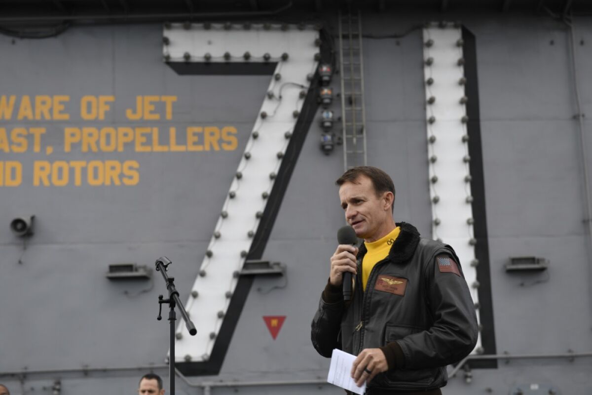 Capt. Brett Crozier, then the commanding officer of the aircraft carrier USS Theodore Roosevelt, addresses the crew during an all-hands call on the ship’s flight deck. Crozier was removed from command Thursday after a letter he wrote asking for the Navy's help with a COVID-19 outbreak on board was widely disseminated.