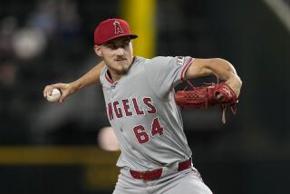 Los Angeles Angels starting pitcher Jack Kochanowicz throws to the Texas Rangers.