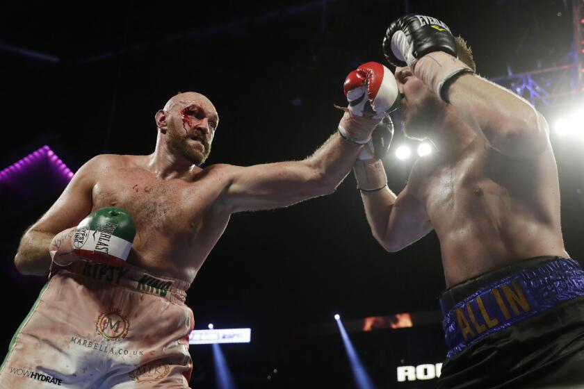 Tyson Fury, left, of England, punches Otto Wallin, of Sweden, during their heavyweight boxing match Saturday, Sept. 14, 2019, in Las Vegas. (AP Photo/Isaac Brekken)