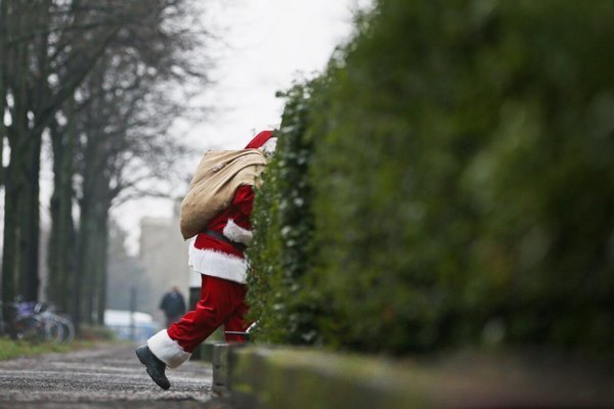 A man dressed as Santa Claus walks through a street in Hamburg, Germany.