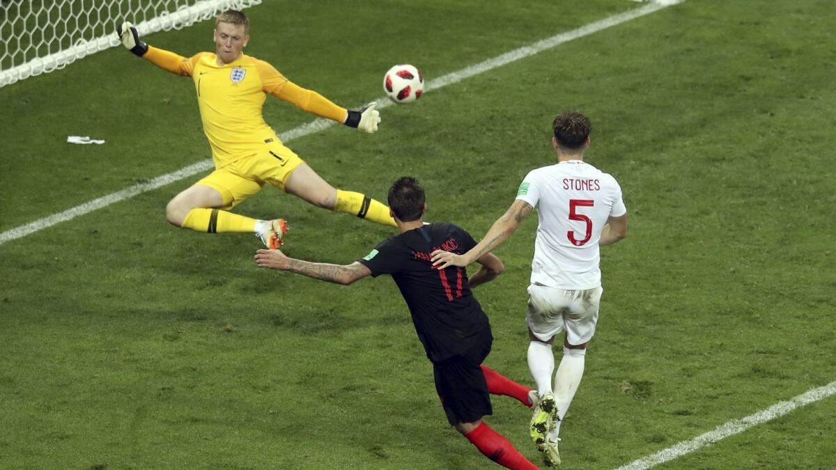 Mario Mandzukic, center, scores Croatia's second goal during the World Cup semifinal against England on July 11 in Moscow.