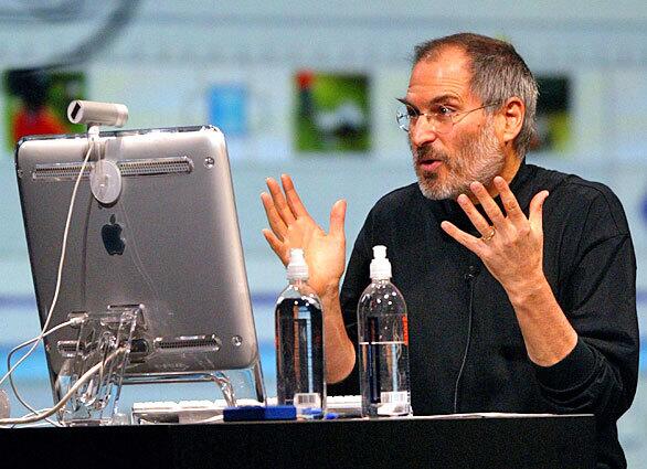Jobs gestures as he delivers a keynote address at the 2004 MacWorld conference. Jobs announced several new products including the new iLife 4 software and the iPod Mini.