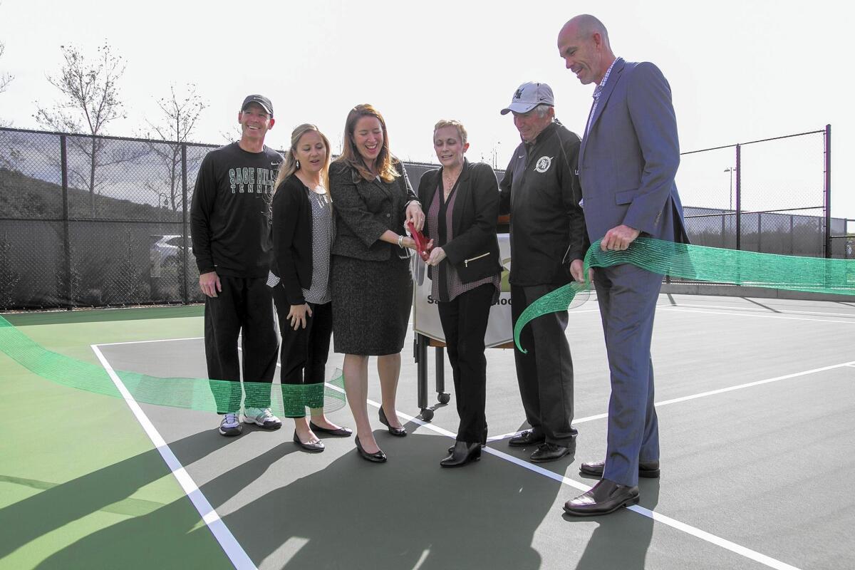 From left, Mark Watkins, Megan Cid, Patricia Merz, Christy Marlin, A.G. Longoria and Gordon McNeill take part in a ribbon-cutting ceremony for the new tennis center at Sage Hill School on Friday.