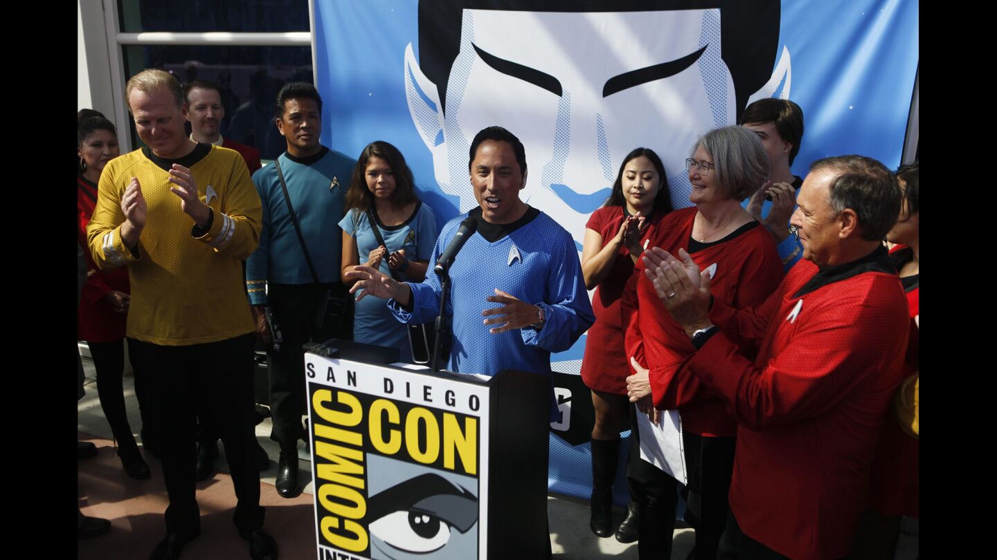 San Diego Councilman Todd Gloria, center, welcomes people to Comic-Con in front of the San Diego Convention Center.