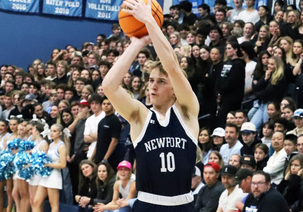 Newport Harbor's Dean Davis (10) shoots a three-pointer against Corona del Mar in the Battle of the Bay on Saturday.