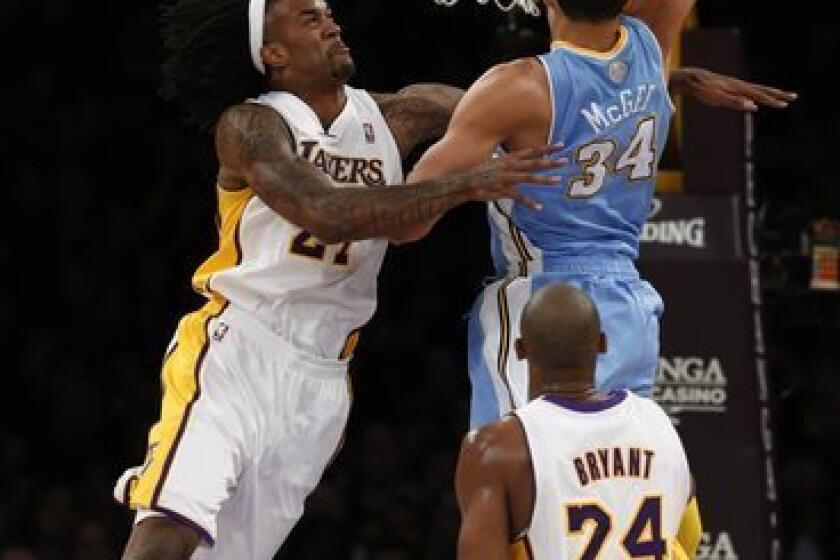Nuggets center JaVale McGee tries to dunk over Jordan Hill during the game in which Hill was injured.