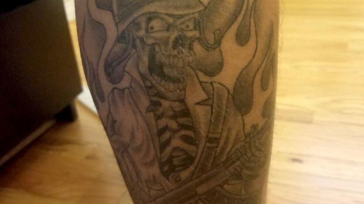 A L.A. County sheriff's deputy inked on his calf with a skull tattoo associated with the Compton station